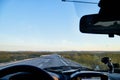 View from car windscreen to highway and tundra in evening time Royalty Free Stock Photo