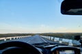 View from car windscreen to highway and tundra in evening time Royalty Free Stock Photo