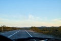 View from car windscreen to highway and tundra in evening time Royalty Free Stock Photo