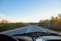 View from car windscreen to highway and tundra in evening time Royalty Free Stock Photo