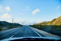 View from car windscreen to highway, tundra and hills in evening time. Polar day in Norway Royalty Free Stock Photo