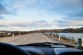 View from car windscreen to highway, tundra and hills in evening time. Polar day in Norway Royalty Free Stock Photo