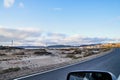 View from car windscreen to highway, tundra and hills in evening time. Polar day in Norway Royalty Free Stock Photo