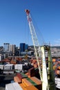 View on cargo crane with spreader to handling containers situated in merchant terminal. Royalty Free Stock Photo