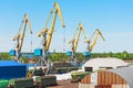 View of the cargo port, with high sea cranes for loading goods and cargo to ships from the pier of the railway station. Royalty Free Stock Photo