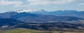 View of the Carpathian Mountains landscape in cloudy summer day. Mountain peaks, forests, fields and meadows, beautiful natural Royalty Free Stock Photo