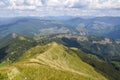 View of the Carpathian Mountains landscape in cloudy summer day. Mountain peaks, forests, fields and meadows Royalty Free Stock Photo