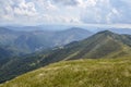 View of the Carpathian Mountains landscape in cloudy summer day. Mountain peaks, forests, fields and meadows Royalty Free Stock Photo