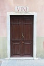 View of Carrara, Tuscany: ancient wood door of a wine shop with marble sign and the text: wine Royalty Free Stock Photo