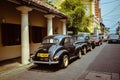 View of the cars parked in the Dickwella street on a sunny day in Sri Lanka