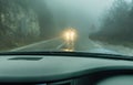 View through the cars windshield in the winter fog on the road