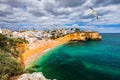 View of Carvoeiro fishing village with beautiful beach, Algarve, Portugal. View of beach in Carvoeiro town with colorful houses on