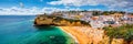 View of Carvoeiro fishing village with beautiful beach, Algarve, Portugal. View of beach in Carvoeiro town with colorful houses on