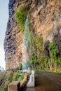view of Cascata dos anjos, waterfall on the road, Madeira, Portugal on sunny winter day