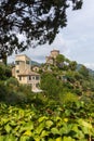 View of Castello Brown, 16th century museum in Portofino in Italy. Trees and greenery around the historic building