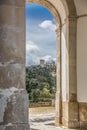 View of the castle and fortress of Obidos, between arches pillars of Lord Jesus of the Stone Sanctuary Royalty Free Stock Photo