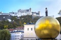 View of Fortress Hohensalzburg and man figure on big golden ball, Salzburg, Salzburger Land, Austria