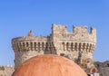 View of castle roof tower with red building roof and very clear blue sky