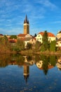 View Of The Cityscape Of Telc And Reflection In Water.