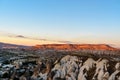 View of cave houses and rock formations at sunset. Goreme. Cappadocia. Turkey Royalty Free Stock Photo