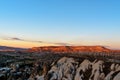 View of cave houses and rock formations at sunset. Goreme. Cappadocia. Turkey Royalty Free Stock Photo