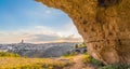 View through cave of sassi di Matera,basilicata, Italy, UNESCO under blue sky and sun flare