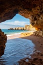 View from cave to beach surrounded by cliffs at beach Coelha Royalty Free Stock Photo
