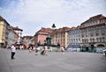 View of the central square of Graz, with the large fountain in the center and the historic buildings that act as corollala, under
