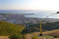 View of chairlift in Caucasus mountains in Gelendzhik resort city. Bay and Black sea shore in background at sunset in