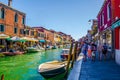 view of a channel on murano island in italy which is surrounded with tourist shops selling famous murano glass...IMAGE