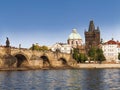 View of the Charles bridge over the Vltava river, the bridge tower and the church of St. Francis of Assisi in Prague. Royalty Free Stock Photo