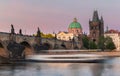 View on Charles bridge over Vltava river during colorful pink sunset Royalty Free Stock Photo