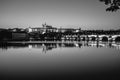 View on Charles Bridge and Prague Castle over Vltava River during early night with wonderful blue sky and yellow city Royalty Free Stock Photo