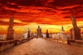 View of Charles Bridge in Prague with dramatic red and yellow sky and clouds, Czech Republic. Prague during sunset.