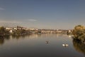 View of the Charles Bridge and the Vltava River on a sunny day in the city of Prague with a boat on the surface Royalty Free Stock Photo