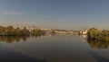 View of the Charles Bridge and the Vltava River on a sunny day in the city of Prague with a boat on the surface Royalty Free Stock Photo