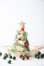 View of cheese tree with dill, rosemary, cherries and pomegranate, with Christmas decorations Royalty Free Stock Photo