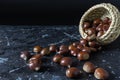 View of chestnuts falling from a wicker basket Royalty Free Stock Photo