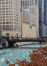 View of Chicago River with ice chunks and tree in foreground with Civic Opera House in background. Royalty Free Stock Photo