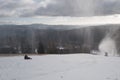 Children on a bobsleigh ride downhill past a snow maker Royalty Free Stock Photo