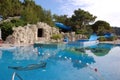 View of the children`s pool with a stylized cave entrance and wa