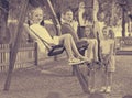 View on children swinging together on children's playground Royalty Free Stock Photo