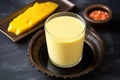 view of a chilled glass of mango lassi from the top angle