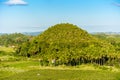 View of Chocolate Hills in Bohol. Flanked by coconut trees and a small farm. In Sagbayan, Bohol Royalty Free Stock Photo