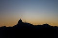 Silhouette of Christ the Redeemer Cristo Redentor at the top of mount Corcovado just after sunset during dusk in Rio de Janeiro