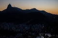 Sunset view of Christ the Redeemer on top of Mount Corcovado overlooking the city of Rio de Janeiro lit up at dusk in Rio, Brazil