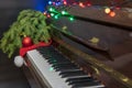 Old piano with keys. Selective focus. Christmas tree with Christmas lights and toys Royalty Free Stock Photo