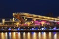 View of Christmas Moscow with a soaring bridge over the Moscow river, new year installations in the form of glowing trees and colo