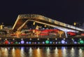 View of Christmas Moscow with a soaring bridge over the Moscow river, new year installations in the form of glowing trees and colo