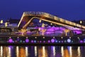 View of Christmas Moscow with a soaring bridge over the Moscow river, new year installations in the form of glowing trees and colo